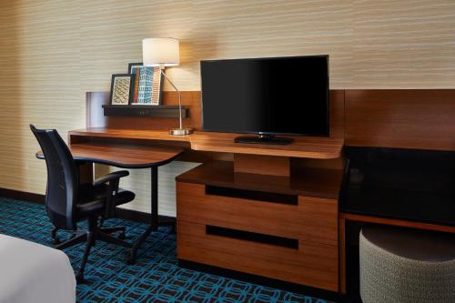 a hotel room with a desk with a television on it at Fairfield Inn & Suites by Marriott Atlanta Lithia Springs in Lithia Springs