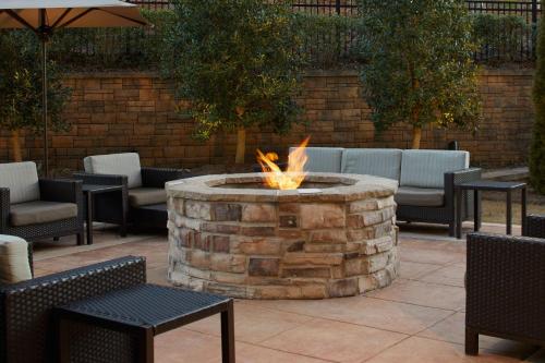 a fire pit in a patio with tables and chairs at Fairfield Inn & Suites by Marriott Atlanta Lithia Springs in Lithia Springs