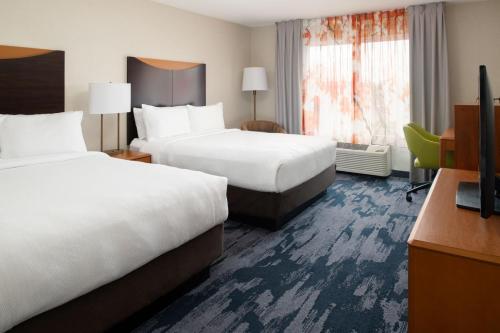 a hotel room with two beds and a television at Fairfield Inn & Suites by Marriott Portland Airport in Portland