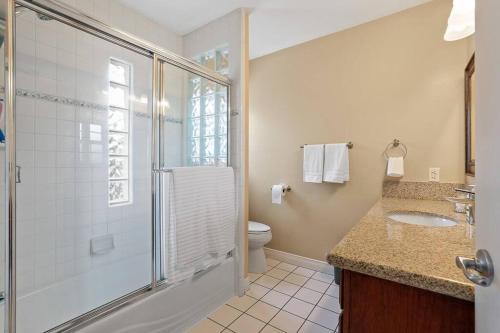 a bathroom with a shower and a toilet and a sink at Resort style home, Pool/Spa/Game room near Disney in Anaheim
