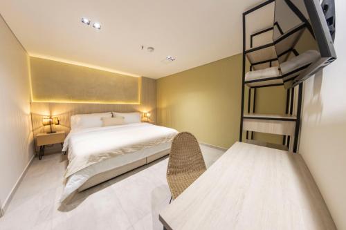 a bedroom with a white bed and a bunk bed at Sonata 44 Hotel Laureles in Medellín