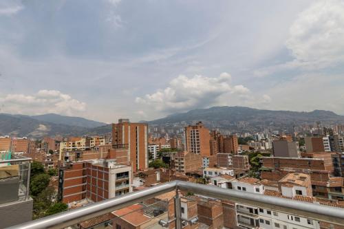 a view of a city with buildings and mountains at Sonata 44 Hotel Laureles in Medellín