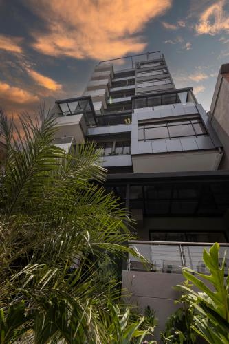 a tall building with a lot of windows at Sonata 44 Hotel Laureles in Medellín