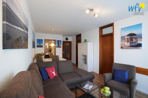 a living room with a couch and two chairs at Ferienhaus Seeblick - Wohnung 26 in Borkum