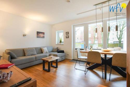 a living room with a couch and a table at Appartement-Haus Regina Ferienwohnung Sonnendeck in Borkum