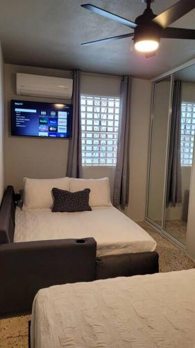 a bedroom with two beds and a ceiling fan at Trujillo Alto Quiet and Cozy, Fully Equipped and Pet-Friendly in Trujillo Alto