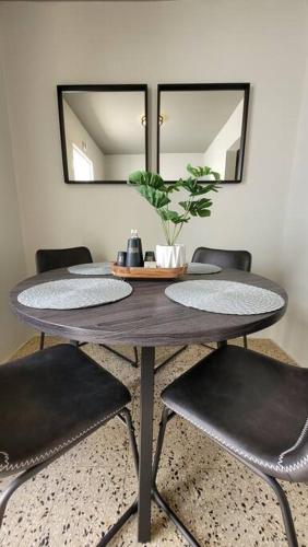 a dining room table with chairs and a mirror at Trujillo Alto Quiet and Cozy, Fully Equipped and Pet-Friendly in Trujillo Alto