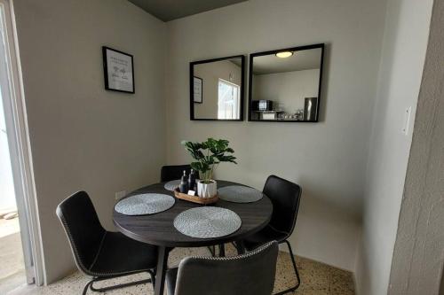 a dining room table with chairs and a mirror at Trujillo Alto Quiet and Cozy, Fully Equipped and Pet-Friendly in Trujillo Alto