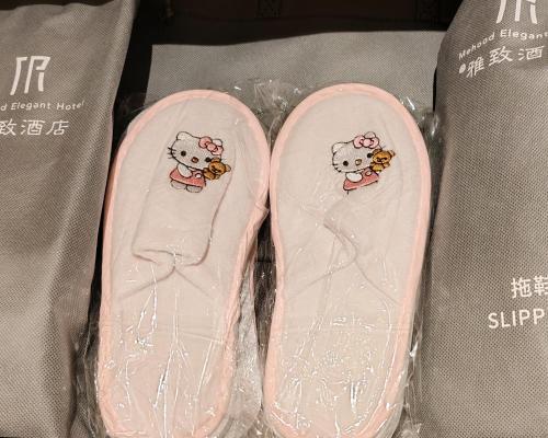 two hello kitty shoes with hello kitty stickers on them at Mehood Elegant Hotel Guangzhou Baiyun Airport Huadu Cultural Tourism City in Huadong