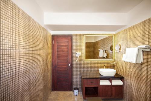 een badkamer met een wastafel en een spiegel bij ANGKASA LADAKH RESORT in Leh