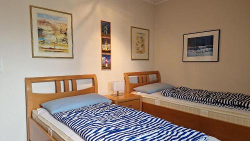 two beds sitting next to each other in a room at Landhaus-am-Golfplatz-9 in Sankt Peter-Ording