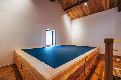 a room with a bed in the middle of it at サウナ付き一棟貸し宿 大岡辻-tsuji oooka- in Ookanakamaki