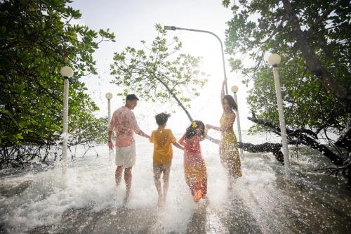 a group of people playing in the water at Bintan Exotica Resort in Berakit