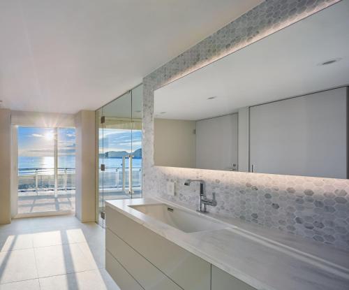 a bathroom with a sink and a large mirror at THE VIEW KAMAKURA in Kamakura