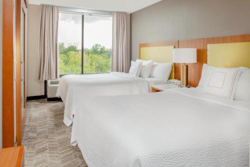 a hotel room with two beds and a window at SpringHill Suites Cincinnati North Forest Park in Springdale