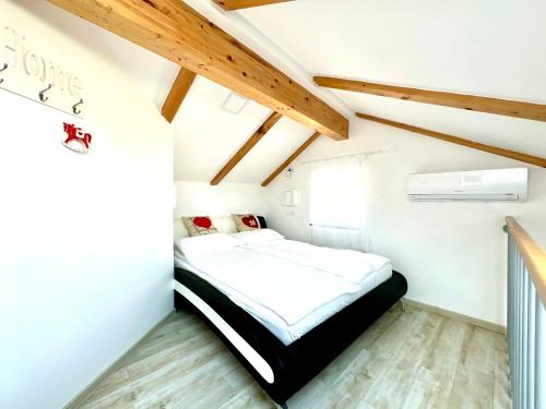 a bedroom with a bed in a room with wooden ceilings at Old Piran Starfish in Piran