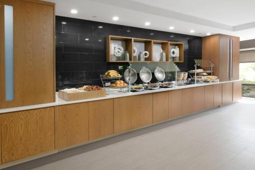 a buffet line in a hotel with food on display at SpringHill Suites Dallas Addison/Quorum Drive in Addison
