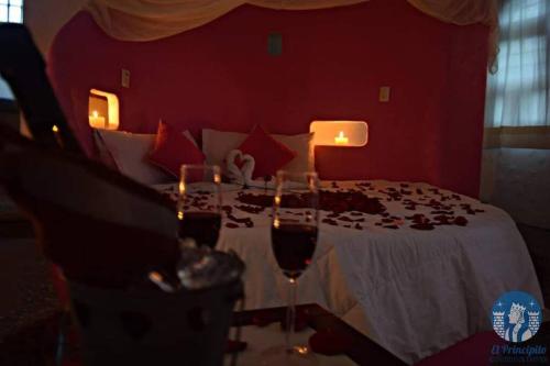 1 dormitorio con 1 cama con copas de vino en El Castillo Mágico (Estancia Inolvidable) LZC, en Lázaro Cárdenas