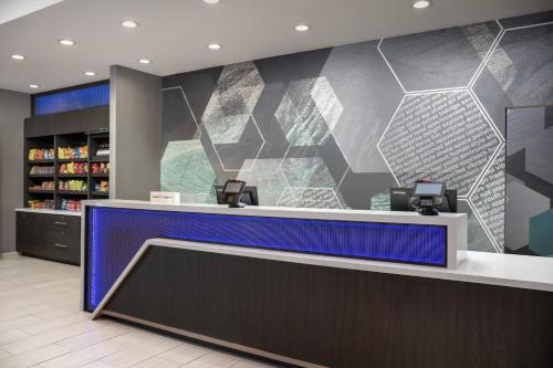 a cashier counter in a store with a blue at SpringHill Suites by Marriott Birmingham Gardendale in Gardendale