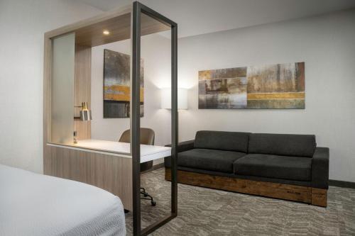 a hotel room with a couch and a desk at SpringHill Suites by Marriott Birmingham Gardendale in Gardendale