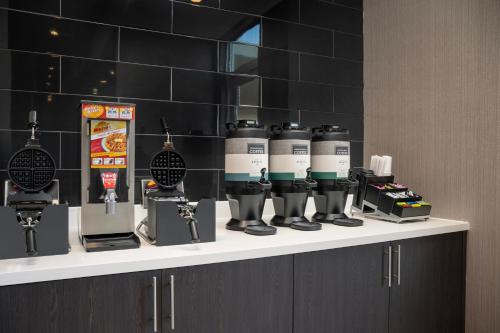 a group of coffee machines sitting on a counter at SpringHill Suites by Marriott Birmingham Gardendale in Gardendale