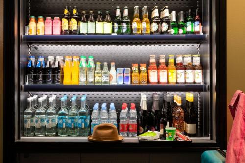 a refrigerator filled with lots of different types of drinks at Moxy Outletcity Metzingen in Metzingen
