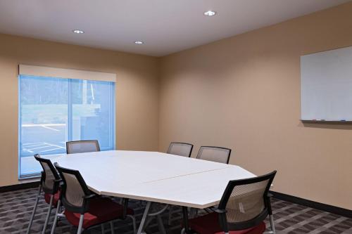 a conference room with a white table and chairs at TownePlace Suites by Marriott Edgewood Aberdeen in Belcamp