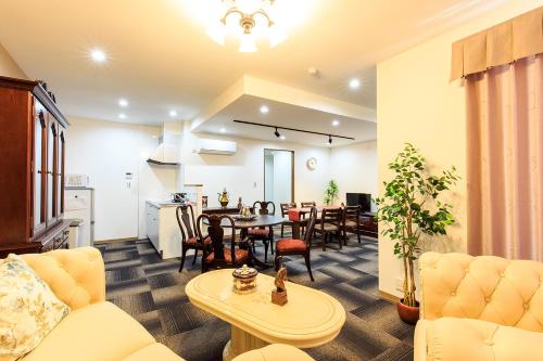 a living room with a couch and a table at #10 Nagoya Sunflower Condominium in Yadachō
