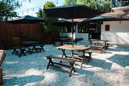 a group of picnic tables with umbrellas on the ground at BOTANIQ HOTEL BOUTIQUE in Valle de Bravo
