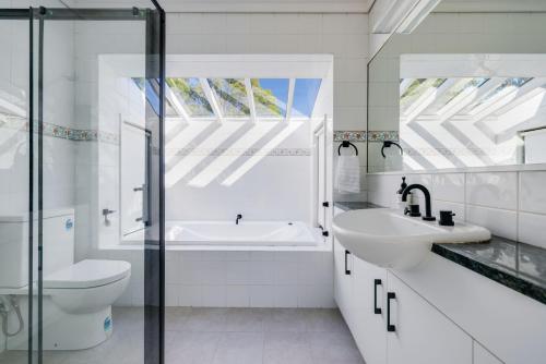 Baño blanco con lavabo y aseo en The Mediterranean - Escape to Tranquility Save Up to 350 this May and June en Falls Creek