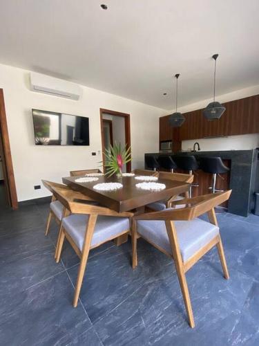 a wooden table and chairs in a living room at ¡New Villa 4BR with priv jacuzzi! in Tulum