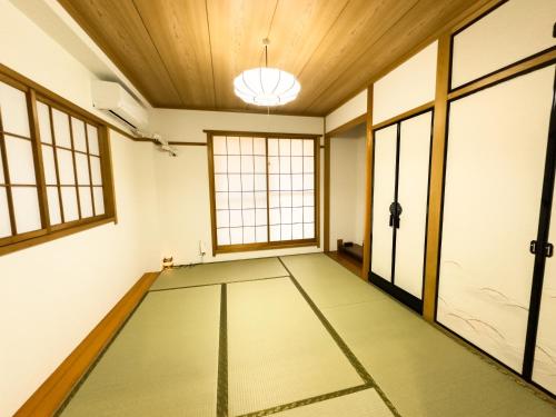 an empty room with a ceiling and windows at X101Near Nagoya Station detached hous 12 people in Nagoya