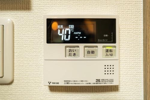 an electronic machine with a clock on top of it at X101Near Nagoya Station detached hous 12 people in Nagoya