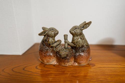 two figurines of two rabbits sitting on a table at X101Near Nagoya Station detached hous 12 people in Nagoya