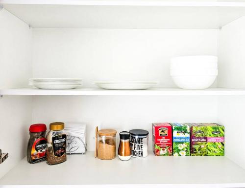 a shelf in a kitchen filled with food items at [Trendy Suite] Centro città + Garage in Cuenca