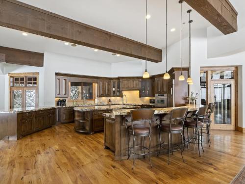an open kitchen with a large island with bar stools at Apex Lodge SOL-12011 in Salt Lake City
