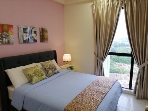 a bedroom with a bed and a large window at Astetica Residences @ Seri Kembangan in Seri Kembangan