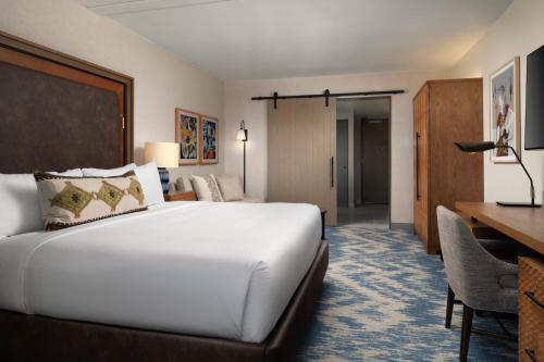 a hotel room with a bed and a desk at Plaza San Antonio Hotel & Spa, Autograph Collection in San Antonio