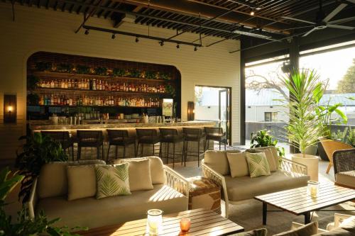 a restaurant with couches and a bar in the background at Plaza San Antonio Hotel & Spa, Autograph Collection in San Antonio