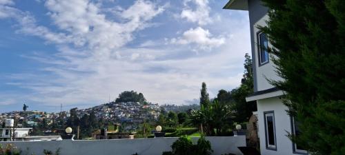 a view of a city from a building at Magizham Homestay in Kodaikānāl