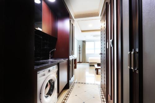 a laundry room with a washer and dryer at Intercity Seoul Hotel in Seoul