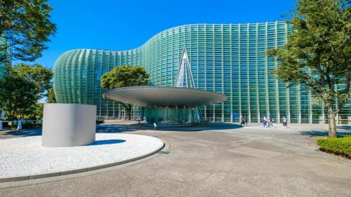 a large glass building with a fountain in front of it at Toyoko Inn Tokyo Tameike-sanno-eki Kantei Minami in Tokyo
