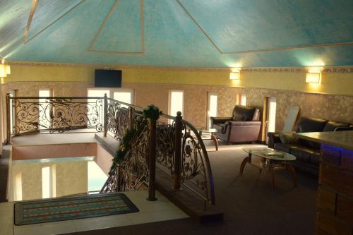 a room with a staircase and a living room at Golden Palace in Dubove
