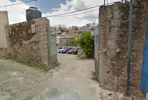 an alley with a fence next to a parking lot at Casa Estudio Frida y Diego Rivera by Lunian in Guanajuato