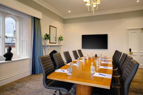 a conference room with a large wooden table and chairs at Delta Hotels by Marriott St Pierre Country Club in Chepstow