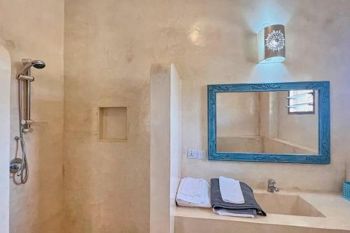 a bathroom with a sink and a mirror at Beach Apartment 4 Passi Residence in Watamu