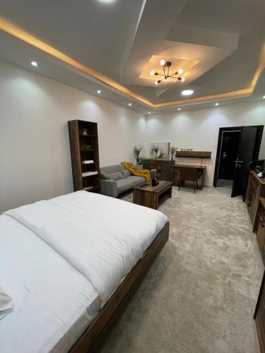 a bedroom with a bed and a living room at رال هاوس in Al Wajh