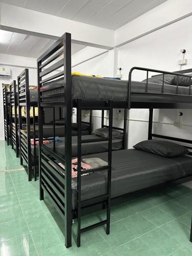 a group of bunk beds in a room at Moon Dance Hostel in Haad Rin