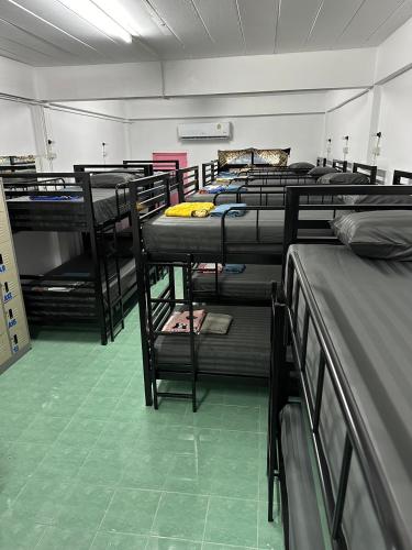 a room with rows of bunk beds in it at Moon Dance Hostel in Haad Rin