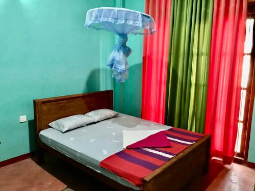 a bedroom with a bed with a umbrella and curtains at Lucky's Homestay in Maho